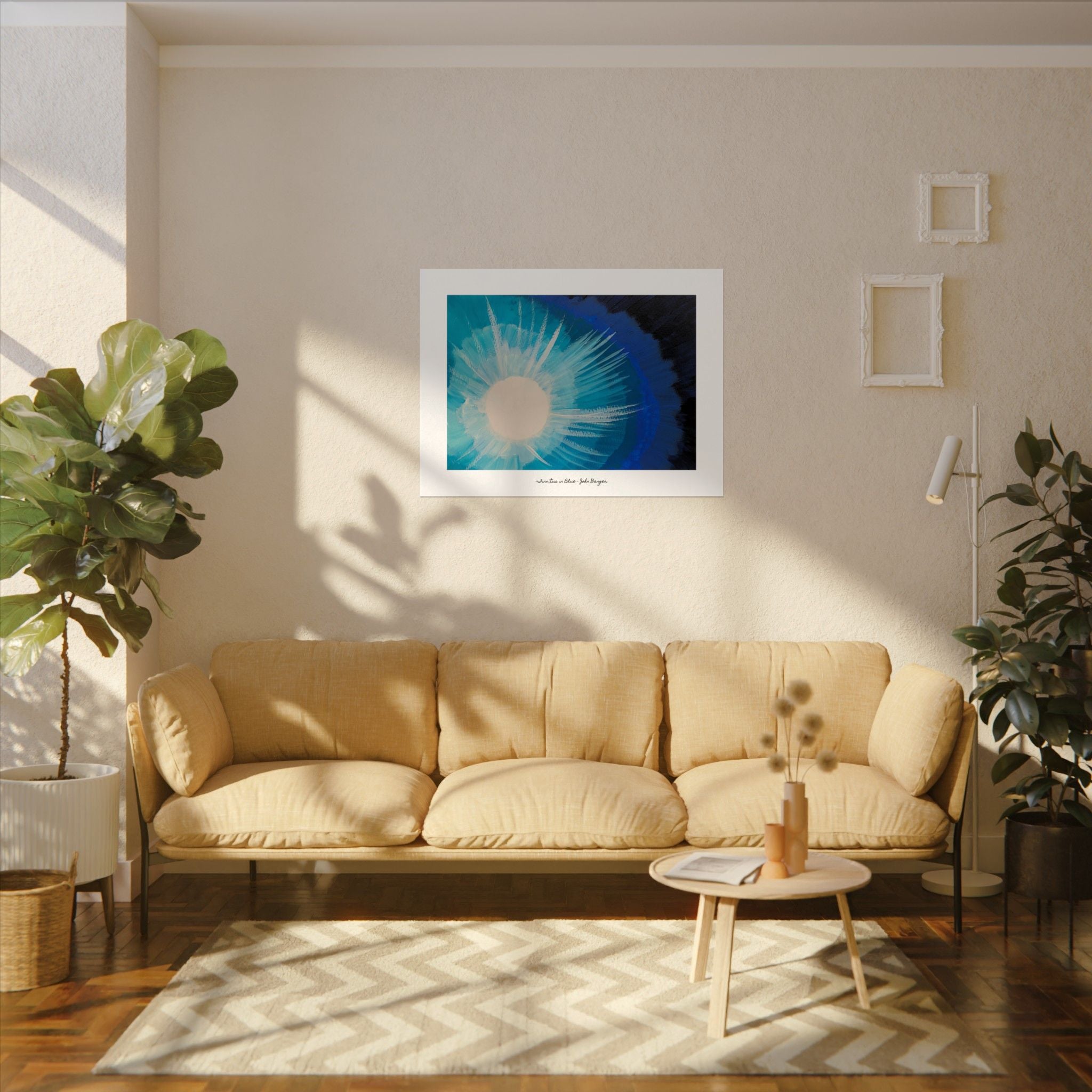Living room with beige sofa, framed artwork on the wall, and plants.